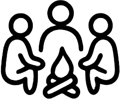 Three people gathered around a campfire