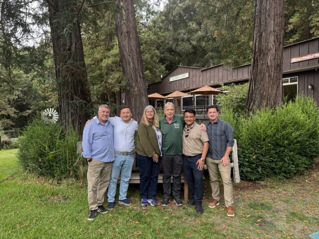 A group of people posing outdoors at a camp.