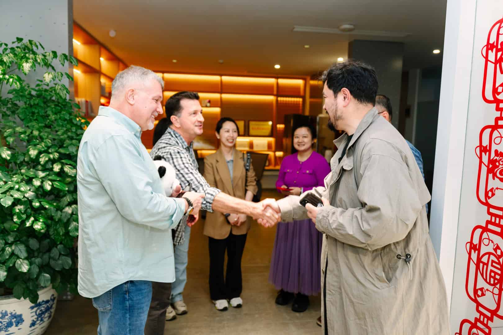 Stuart shakes hands with regional leader on a trip to China