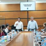 Stuart & Jeff leading a meeting at the head of a large conference table in Uzbekistan