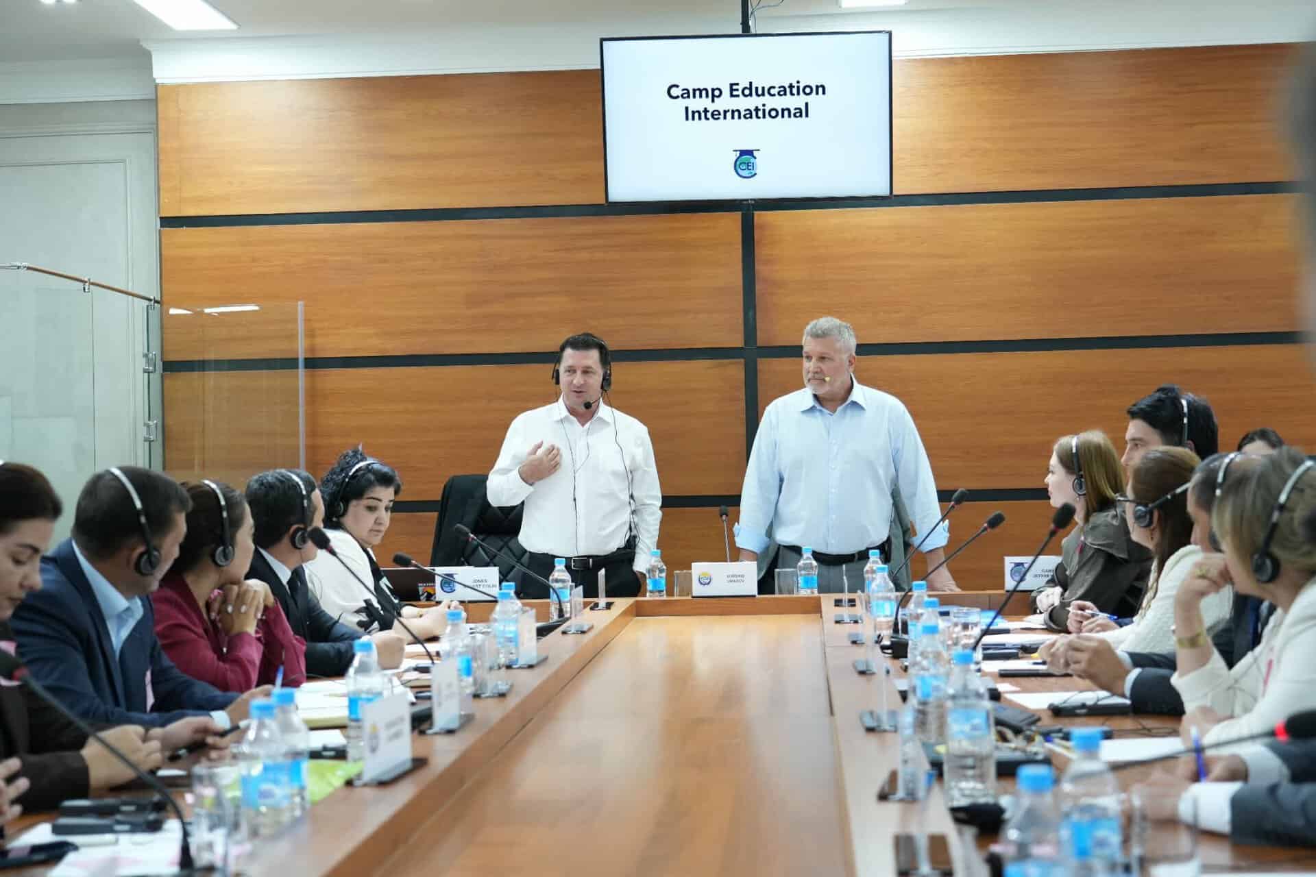 Stuart & Jeff leading a meeting at the head of a large conference table in Uzbekistan