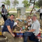 Stuart & Jeff meeting children on a playground in Uzbekistan