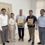 Stuart and Jeff posing with gifts received in Uzbekistan