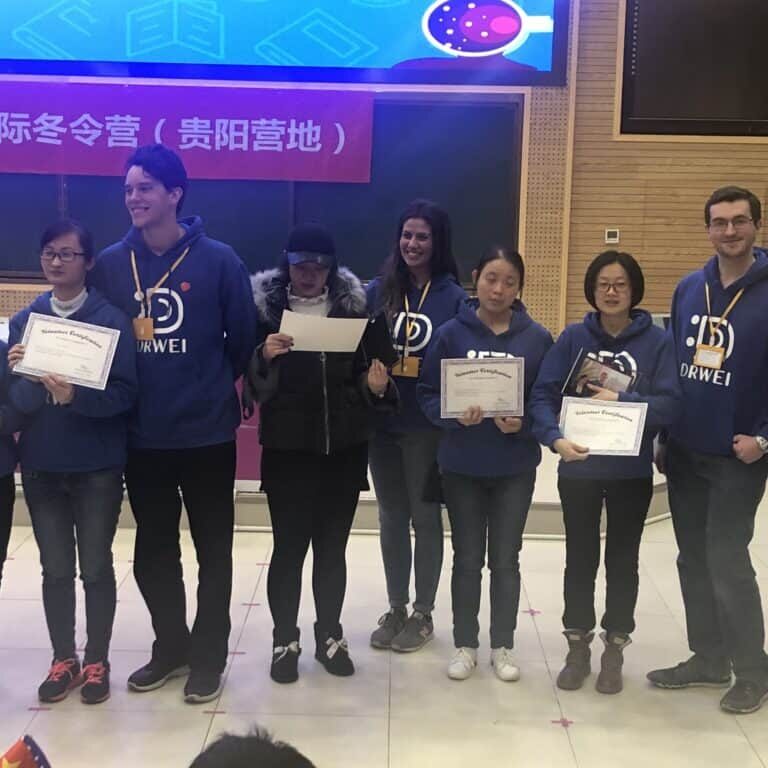 A group of people holding up certificates